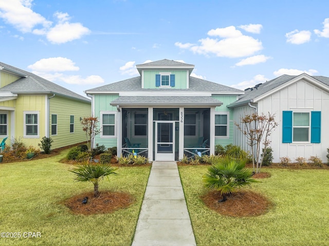 bungalow featuring a front yard and a sunroom