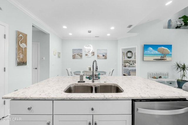 kitchen with white cabinets, dishwasher, a center island with sink, and sink