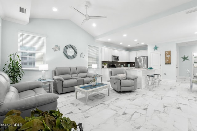 living room featuring ceiling fan and vaulted ceiling