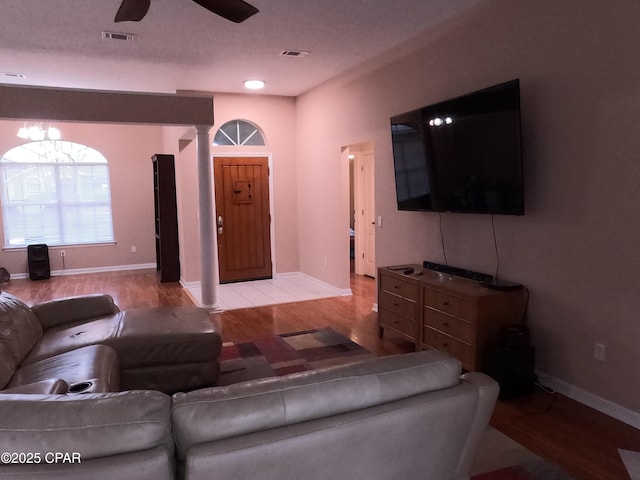 living room featuring ceiling fan and hardwood / wood-style floors