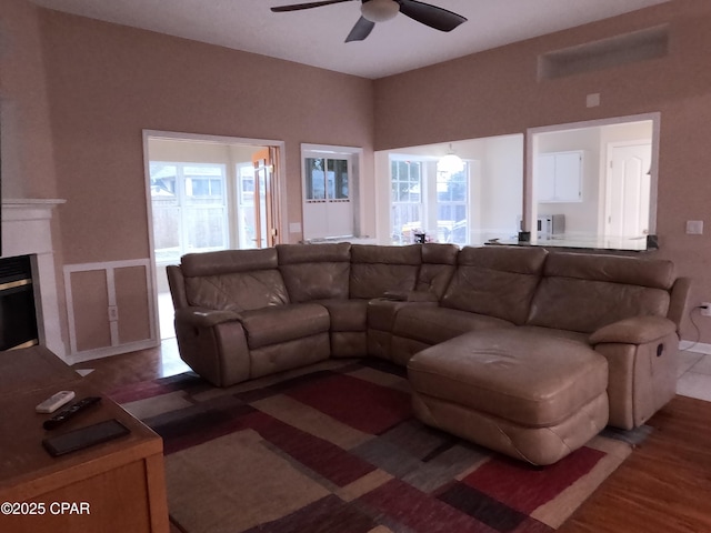 living room with wood-type flooring, ceiling fan, and plenty of natural light