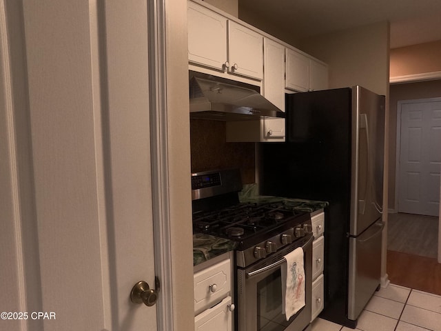 kitchen featuring white cabinets, stainless steel range with gas stovetop, and light tile patterned floors