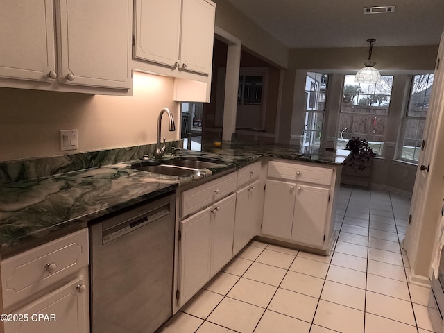 kitchen featuring sink, white cabinetry, light tile patterned flooring, kitchen peninsula, and stainless steel dishwasher