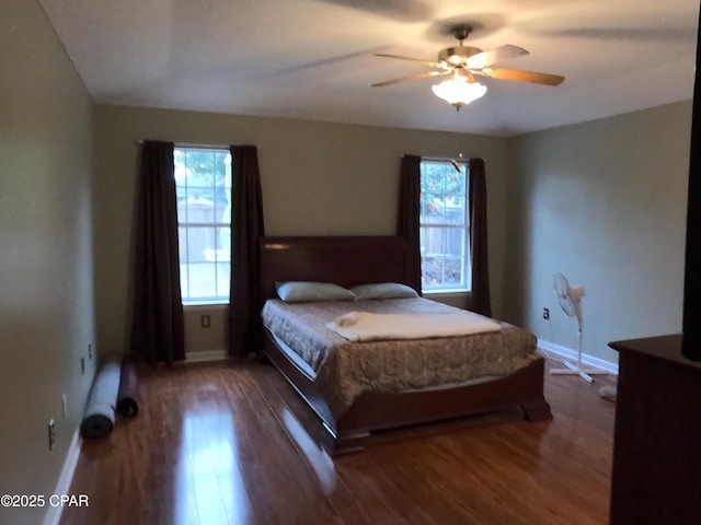 bedroom with ceiling fan and dark hardwood / wood-style floors