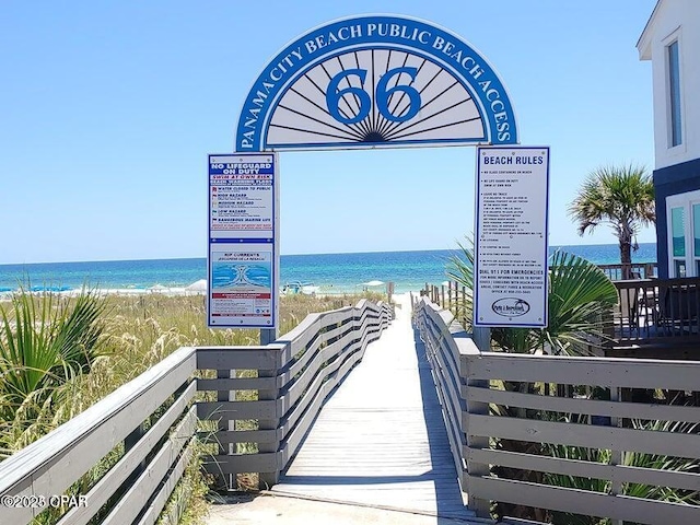 surrounding community featuring a view of the beach and a water view