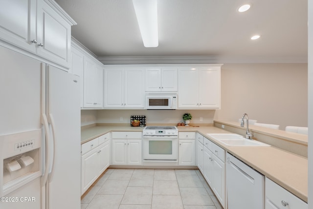 kitchen featuring white cabinetry, white appliances, sink, and light tile patterned floors