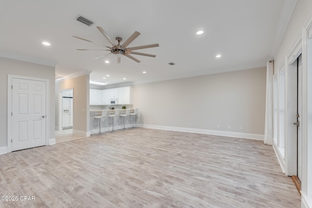 unfurnished living room with crown molding, ceiling fan, and light wood-type flooring