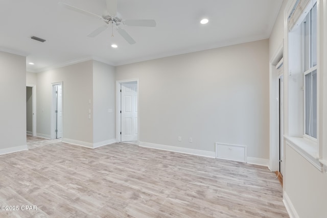 empty room featuring light hardwood / wood-style flooring, ornamental molding, and ceiling fan