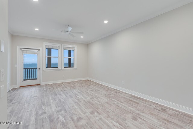 spare room featuring ornamental molding, light hardwood / wood-style floors, and ceiling fan