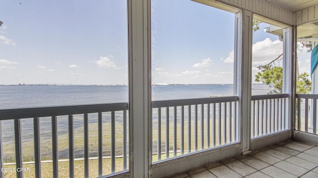 unfurnished sunroom with a water view