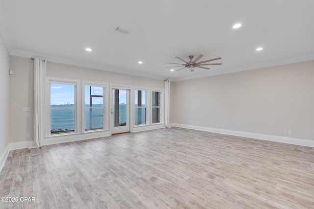 unfurnished room featuring ceiling fan, a water view, light hardwood / wood-style floors, and ornamental molding