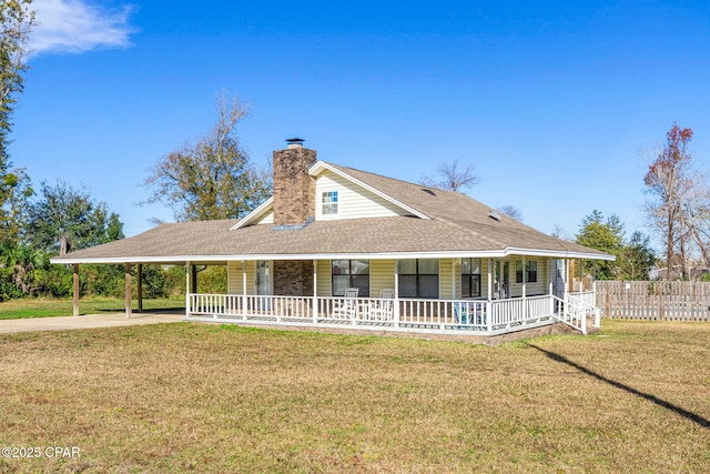 farmhouse with a carport, covered porch, and a front lawn