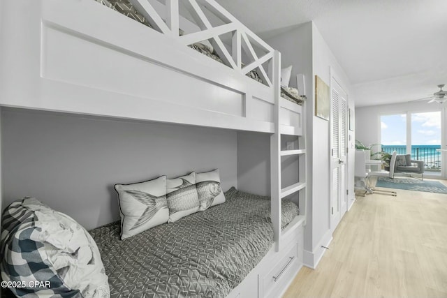 15928 Front Beach Rd Unit 3-1610, Panama City Beach, FL 32413 - bedroom with light wood-style flooring, access to outside, and a water view