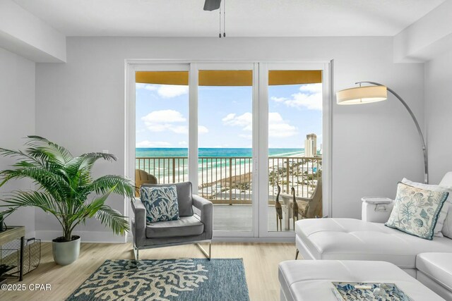 15928 Front Beach Rd Unit 3-1610, Panama City Beach, FL 32413 - living area featuring plenty of natural light, view of water and beach, and wood finished floors