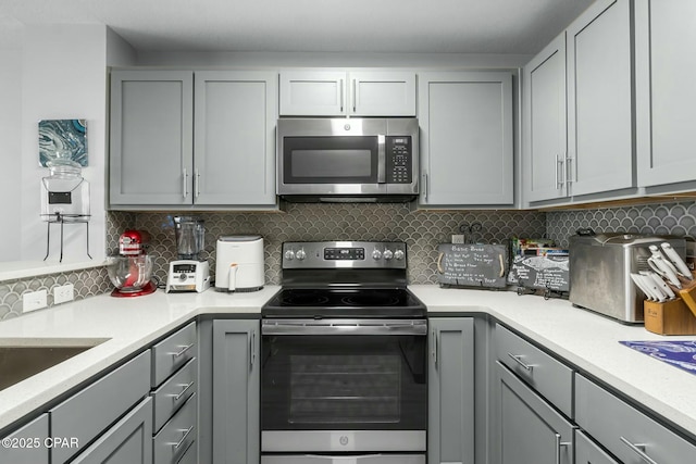 15928 Front Beach Rd Unit 3-1610, Panama City Beach, FL 32413 - kitchen with appliances with stainless steel finishes, gray cabinets, and light countertops