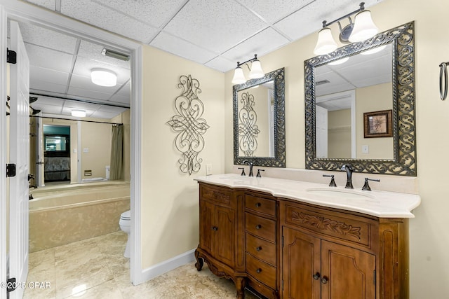 bathroom featuring toilet, tile patterned floors, a paneled ceiling, and vanity