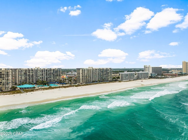 birds eye view of property with a beach view and a water view