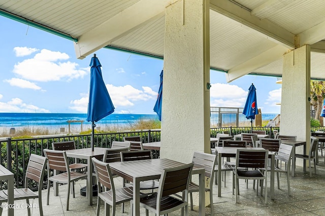 view of patio with a view of the beach and a water view