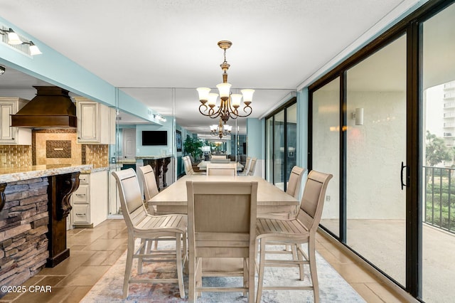 dining space with an inviting chandelier and expansive windows