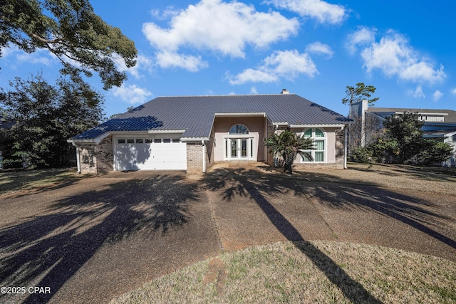 view of front of property featuring a garage and french doors