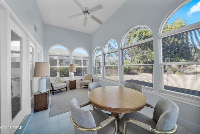 sunroom featuring vaulted ceiling and ceiling fan