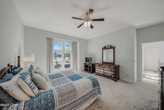 bedroom with light carpet, a textured ceiling, and ceiling fan