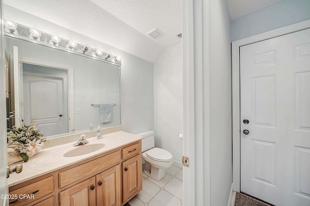 bathroom featuring vanity, toilet, and a textured ceiling