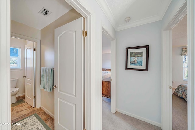 corridor featuring light carpet and a textured ceiling