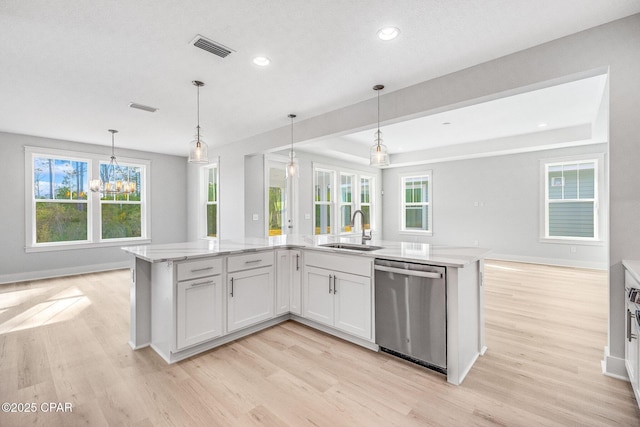 kitchen featuring sink, hanging light fixtures, stainless steel dishwasher, a kitchen island with sink, and white cabinets