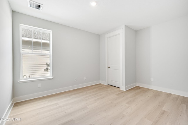 spare room featuring light hardwood / wood-style flooring