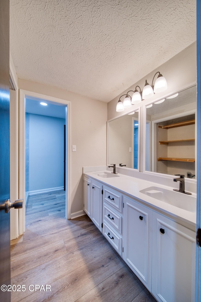 bathroom featuring vanity, a textured ceiling, and hardwood / wood-style floors