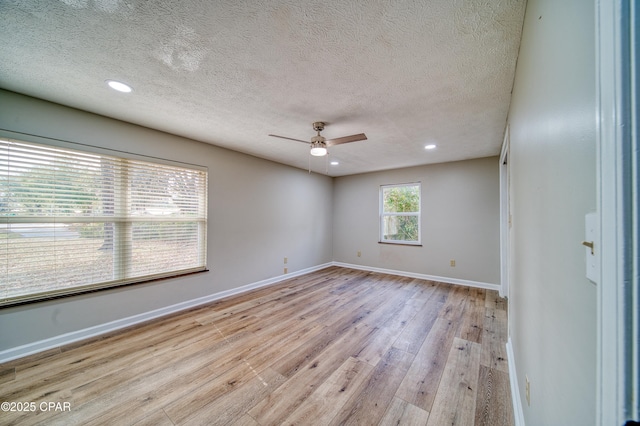 unfurnished room featuring a textured ceiling, ceiling fan, and light hardwood / wood-style floors