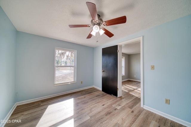 unfurnished bedroom featuring ceiling fan, a textured ceiling, and light hardwood / wood-style flooring