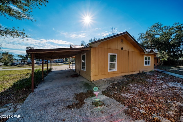 view of property exterior with a carport