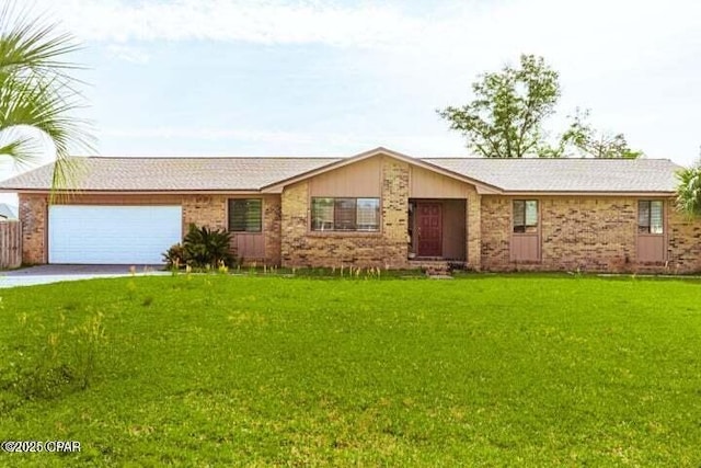 ranch-style home featuring concrete driveway, brick siding, an attached garage, and a front lawn