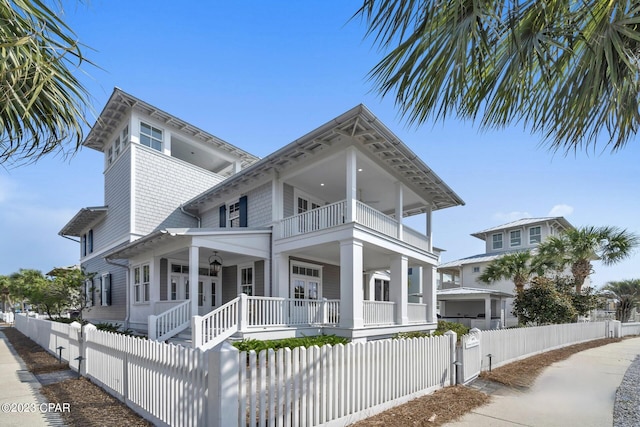 view of front of house featuring a balcony, french doors, and a porch