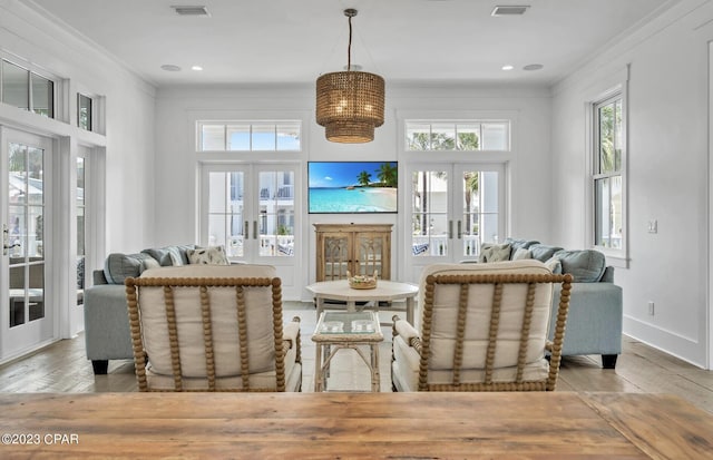 living room with french doors and crown molding