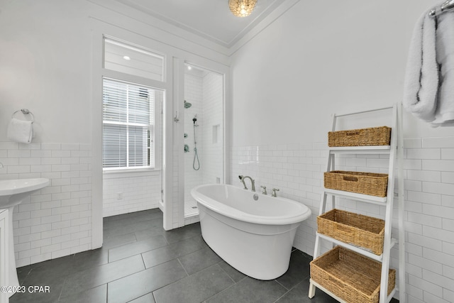 bathroom featuring tile walls, shower with separate bathtub, ornamental molding, and tile patterned floors