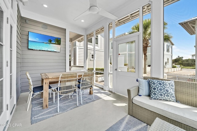 sunroom / solarium featuring ceiling fan