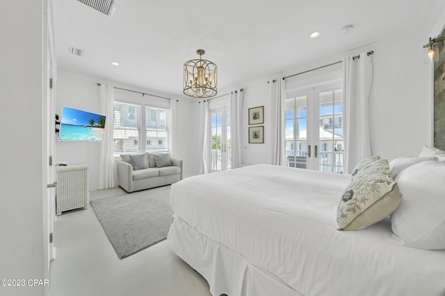 bedroom featuring french doors, access to exterior, and a notable chandelier