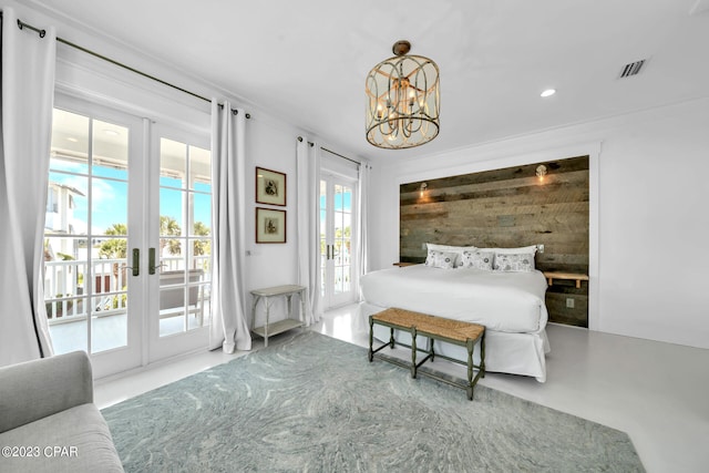 bedroom with concrete flooring, french doors, access to outside, and a chandelier