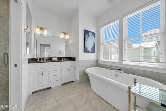 bathroom with vanity, independent shower and bath, and crown molding