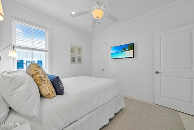 bedroom with ceiling fan and crown molding