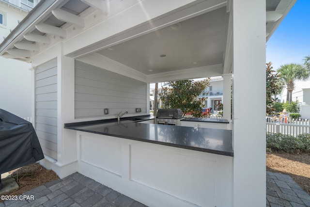 view of patio featuring sink, a grill, and an outdoor kitchen