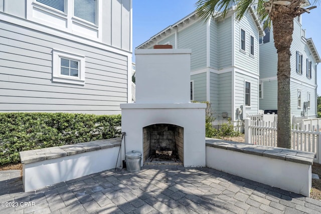 view of patio featuring exterior fireplace