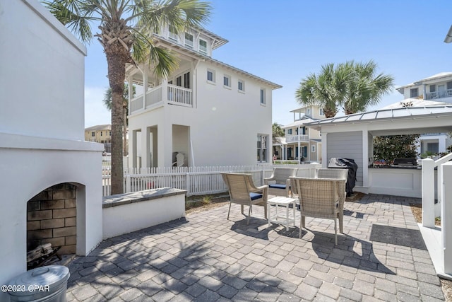 view of patio featuring an outdoor fireplace and area for grilling