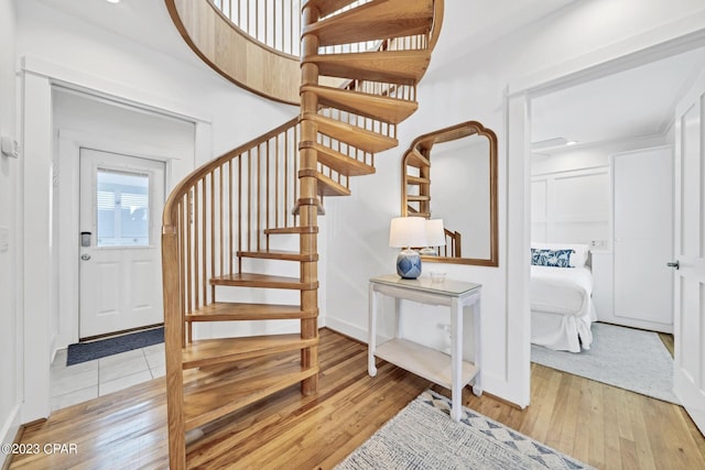 staircase with hardwood / wood-style flooring