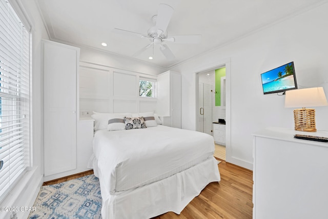 bedroom with ceiling fan, light hardwood / wood-style floors, ensuite bathroom, and ornamental molding