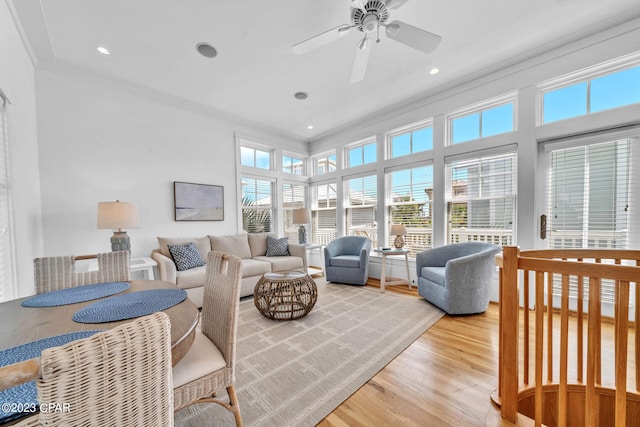 living room featuring ceiling fan, hardwood / wood-style flooring, and crown molding