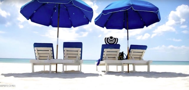 view of patio featuring a beach view and a water view